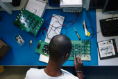boy working on electronics with soldering gun